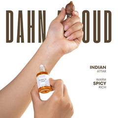 A small amber glass bottle of dahn al oud indian attar with a white label and dropper held with an acorn wooden applicator