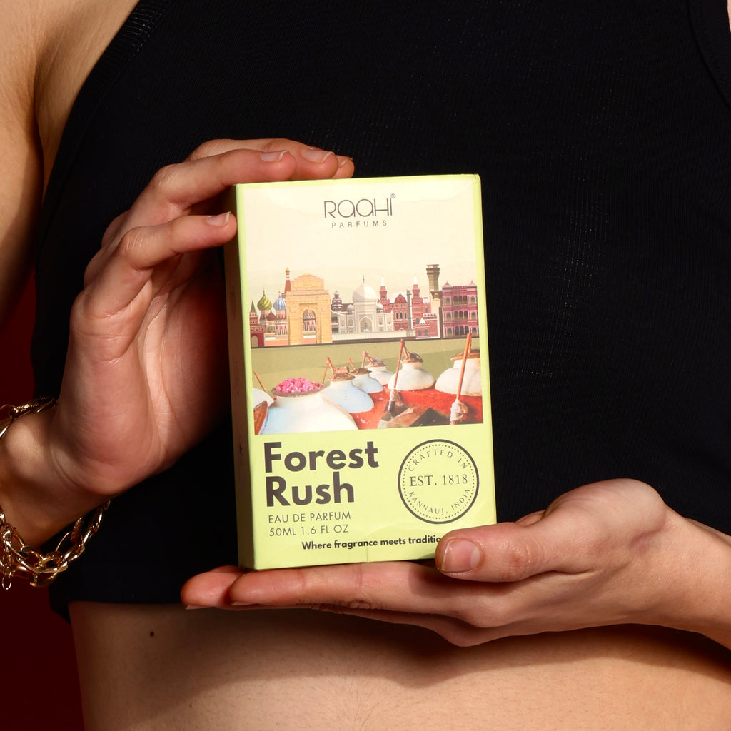A pale green rectangular box of Roohi Parfums Forest Rush eau de parfum with architectural and market illustrations