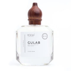Clear glass perfume bottle gulab by roohi parfums with dark brown wooden stopper and minimalist white label