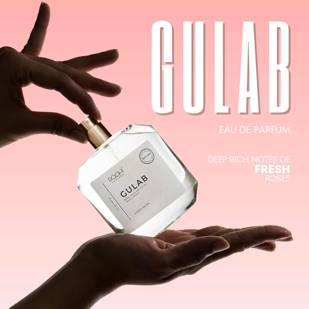 Clear glass bottle with gold-tone spray nozzle and minimalist white label of Gulab eau de parfum by Pooji