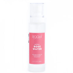 A clear plastic bottle of rqah parfums edible rose water with a pink label made from Kannauj roses 100ml