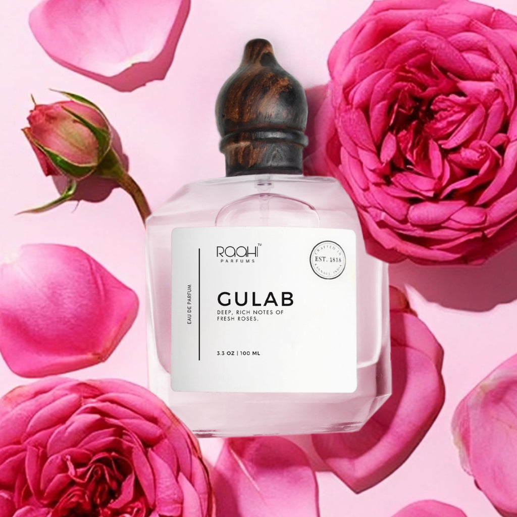 Clear glass gulab eau de parfum bottle with dark wooden cap and white label by roohi parfums