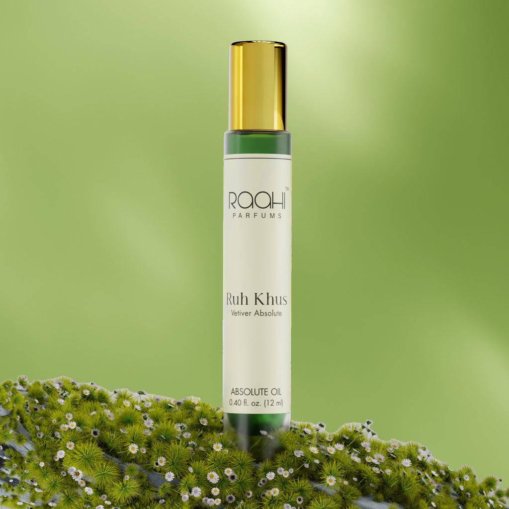 A sleek transparent glass bottle with gold cap and white label containing Raahi Parfums Ruh Khus Vetiver absolute oil 12ml
