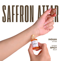 A small amber glass bottle of saffron attar by rooh with a white label and gold cap handcrafted in kannauj india
