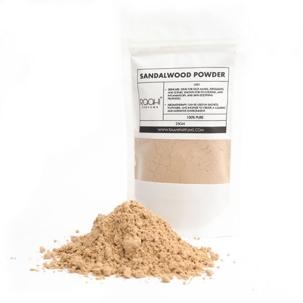 A beige sandalwood powder in a white resealable pouch from roohi perfumes labeled 100 percent pure 25gm
