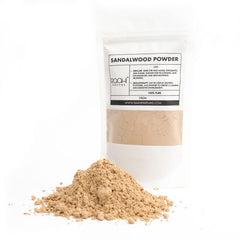 A beige sandalwood powder in a white resealable pouch from roohi perfumes labeled 100 percent pure 25gm